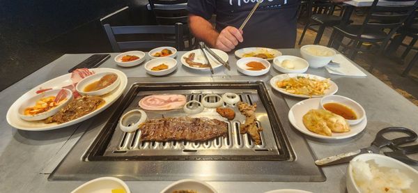 Photo of DAE GEE KOREAN BBQ - Denver, CO, US. a man preparing food