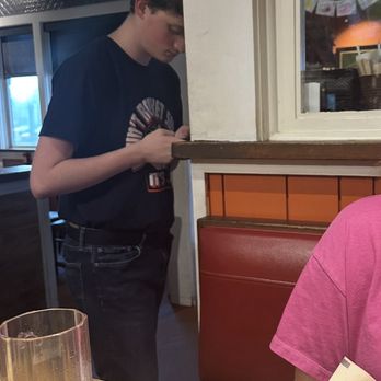 Chili's - Host playing on his phone - American Near Me - Augusta, Georgia Chili's - Host playing on his phone - American Near Me - Augusta, Georgia