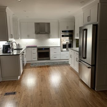 About Kitchens and Baths - a kitchen with white cabinets and wood floors - General Contractors Near Me - Annapolis, Maryland