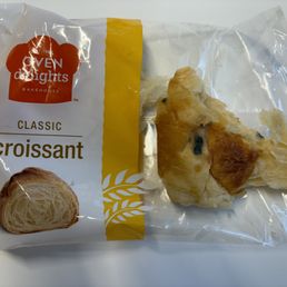 Half of the packaged croissant was covered in dark green mold. Could not see the expiration date on the package as it had been rubbed off.
