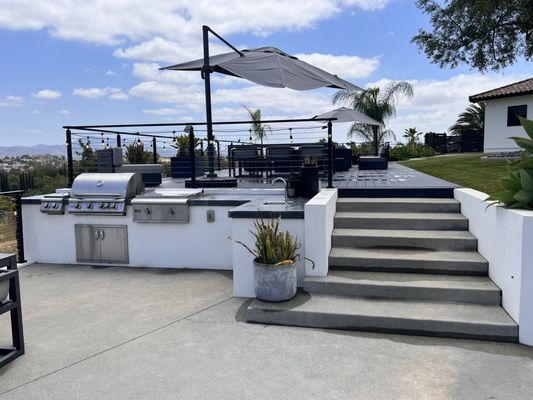 Outdoor Living, BBQs, Fire pits, water features - We’ve gathered some of our favorite outdoor living transformations in beautiful San Diego. From sleek outdoor kitchens perfect for entertaining, to cozy fire pits where stories are shared under the stars, and serene water features that bring tranquility to any space, each project is designed with care and creativity.
Take a look through these snapshots of custom outdoor spaces that blend functionality, comfort, and style. We hope they inspire your next dream project! Outdoor Living, BBQs, Fire pits, water features - We’ve gathered some of our favorite outdoor living transformations in beautiful San Diego. From sleek outdoor kitchens perfect for entertaining, to cozy fire pits where stories are shared under the stars, and serene water features that bring tranquility to any space, each project is designed with care and creativity.
Take a look through these snapshots of custom outdoor spaces that blend functionality, comfort, and style. We hope they inspire your next dream project!