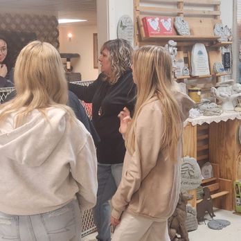 Wild Bird Barn Baraboo Gift Shop - Sales associate Nessa discussing the rehabilitation of a rescued cat with a Volunteer. - Home Decor Near Me - Baraboo, Wisconsin Wild Bird Barn Baraboo Gift Shop - Sales associate Nessa discussing the rehabilitation of a rescued cat with a Volunteer. - Home Decor Near Me - Baraboo, Wisconsin
