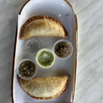 Q’Bo All Dia Cafe - Empanadas with a cilantro lime sauce, and some kind of jalapeño salsa. - Coffee & Tea Near Me - Fairfield, Connecticut Q’Bo All Dia Cafe - Empanadas with a cilantro lime sauce, and some kind of jalapeño salsa. - Coffee & Tea Near Me - Fairfield, Connecticut