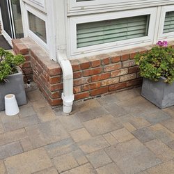 Mason Handyman - This corner was bad, and difficult because of the rain gutter. Looks perfect now. And  the bottom row, next to pavers, is now perfect.