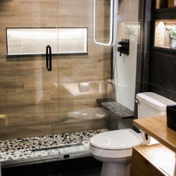 Tim Design & Remodeling - Guest bathroom remoeded. Double shower. Custom lighting. Custom floating vanity.