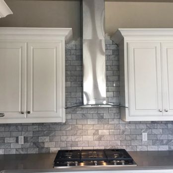 Make Ready Renovations - a kitchen with white cabinets and a stainless steel range hood - General Contractors Near Me - Dallas, Texas Make Ready Renovations - a kitchen with white cabinets and a stainless steel range hood - General Contractors Near Me - Dallas, Texas