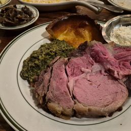 Large Primerib cooked medium rare with buttered spinach, Gullivers corn, sautéed mushrooms, and grilled onions.