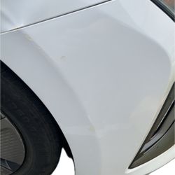 VIP Trans - The passenger right side front bumper sustained visible scraping and paint damage.