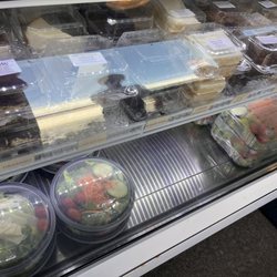 Case with desserts and salads