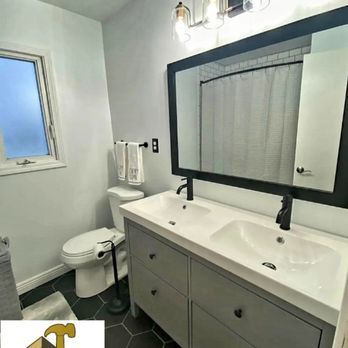 Golden Touch Construction - a bathroom with two sinks and a toilet - General Contractors Near Me Golden Touch Construction - a bathroom with two sinks and a toilet - General Contractors Near Me