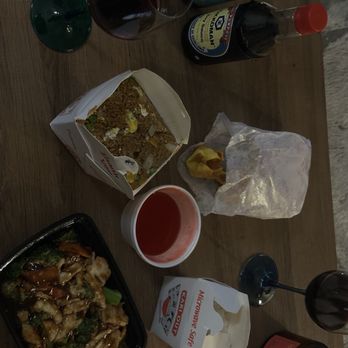 Mandarin House - The table holds Chinese dishes like fried rice and stir-fry, along with drinks including wine and soda, and condiments such as soy sauce. - Chinese Near Me - Tempe, Arizona
