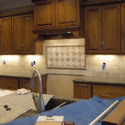 1st Class Cleaning & Flooring - Backsplash with decorative insert over oven