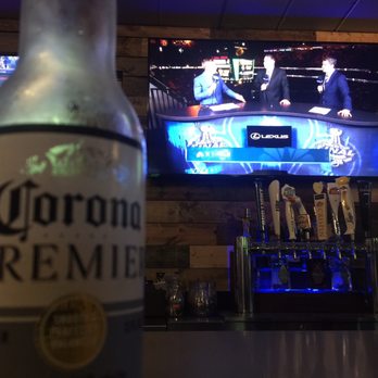 Bar 106 - a bottle of corona premier beer and a television - Sports Bars Near Me - Chicago, Illinois