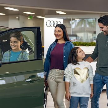Audi Pembroke Pines - Family in the showroom at Audi Pembroke Pines looking at a New Audi at Audi of Pembroke Pines in Florida - Car Dealers Near Me - Pembroke Pines, Florida Audi Pembroke Pines - Family in the showroom at Audi Pembroke Pines looking at a New Audi at Audi of Pembroke Pines in Florida - Car Dealers Near Me - Pembroke Pines, Florida