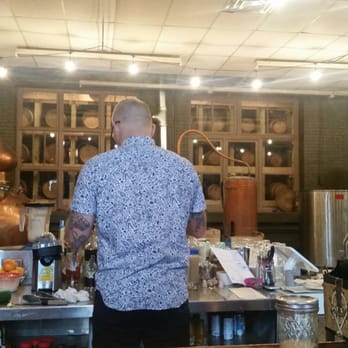 Maggie's Farm Rum - Bartender making drinks. It's really cool how the bar is open to show all of the barrels and the still. - Distilleries Near Me - Pittsburgh, Pennsylvania