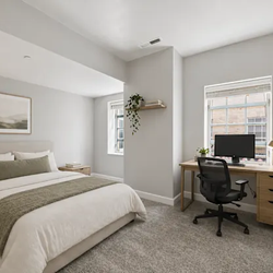 The Landing - Bedroom with upholstered bed and neutral bedding