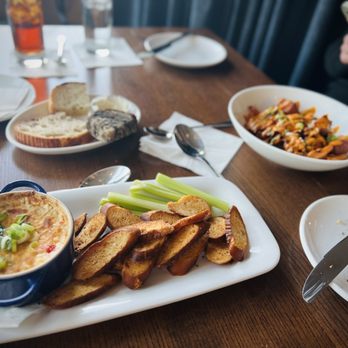 Olive + Oak - Blue Crab Dip (foreground) and Octopus with Roasted Potatoes - Wine Bars Near Me - Saint Louis, Missouri Olive + Oak - Blue Crab Dip (foreground) and Octopus with Roasted Potatoes - Wine Bars Near Me - Saint Louis, Missouri