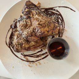 Stuffed French Toast: Brioche, cinnamon ginger custard, sprinkled with powdered sugar and served with syrup. Churro and chocolate.