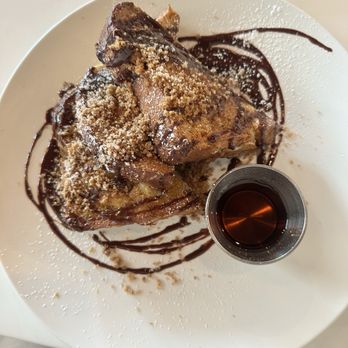 Nutmeg Bakery & Cafe - Stuffed French Toast: Brioche, cinnamon ginger custard, sprinkled with powdered sugar and served with syrup. Churro and chocolate. - Breakfast & Brunch Near Me - Poway, California
