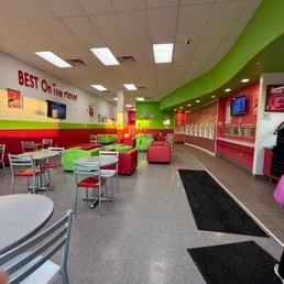 Seating area and ice cream dispenser on the wall. Seating area and ice cream dispenser on the wall.