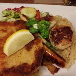 This is the Nolle dish. Breaded schnitzel, sausage patties, kraut and salad.