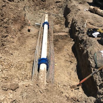 Acres Design and Landscape - a pipe laying on the ground - Landscaping Near Me