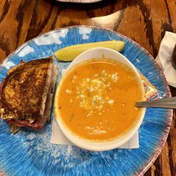 Bay Breeze Cafe - 1/2 Reuben sandwich with tomato and corn bisque topped with blue cheese crumbles