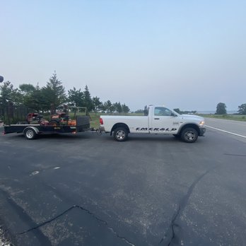 Emerald Companies - a truck towing a trailer - Snow Removal Near Me