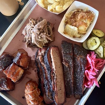 Interstellar BBQ - Mac and Gouda; Scalloped Potatoes; Smoked Lamb Shoulder; Peach Tea Glazed Pork Belly; Brisket; Ducoc Spare Ribs; Smoked Italian Sausage. - Barbeque Near Me - Austin, Texas