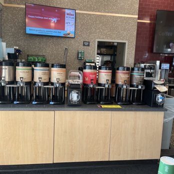 Wawa - a coffee machine and coffee cups on a counter - Gas Stations Near Me - Wesley Chapel, Florida