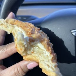 Partially eaten Cheese bomb - so yummy! It's a super soft pandesal with a sweet crumble on top filled with cream cheese. Partially eaten Cheese bomb - so yummy! It's a super soft pandesal with a sweet crumble on top filled with cream cheese.