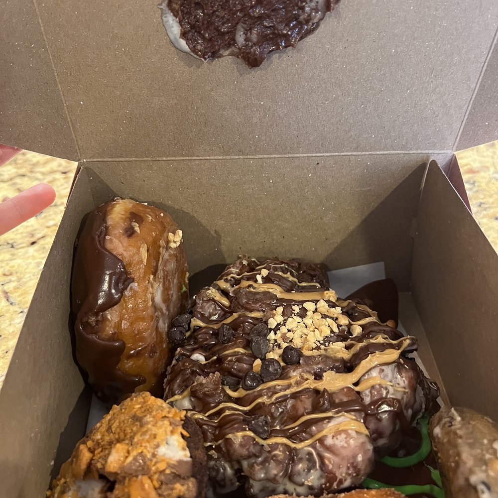 Voodoo Doughnut - Donuts just thrown in an inappropriate donut box haphazardly - Donuts Near Me - Chicago, Illinois Voodoo Doughnut - Donuts just thrown in an inappropriate donut box haphazardly - Donuts Near Me - Chicago, Illinois