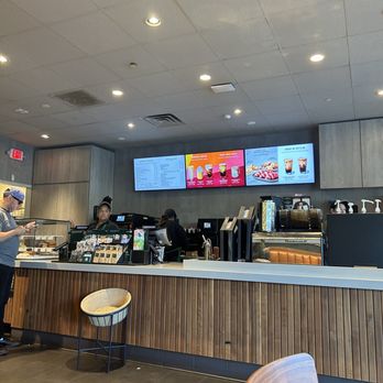 Starbucks - a man standing at a counter in a coffee shop - Coffee & Tea Near Me - Hackensack, New Jersey
