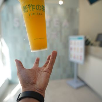Sun Tea - a hand holding a cup of tea - Bubble Tea Near Me - Toronto, Ontario