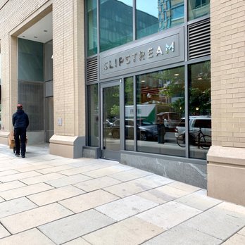 Slipstream - a man walking down a sidewalk in front of a building - Coffee & Tea Near Me - Washington, DC, District of Columbia