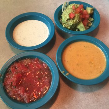 Chuy's - (Clockwise) jalapeno ranch, guac, queso, and salsa - Mexican Near Me - San Antonio, Texas
