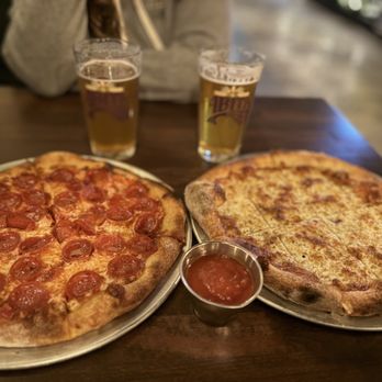 Woodhaus - two pizzas and a beer on a table - Pizza Near Me - Yucaipa, California Woodhaus - two pizzas and a beer on a table - Pizza Near Me - Yucaipa, California