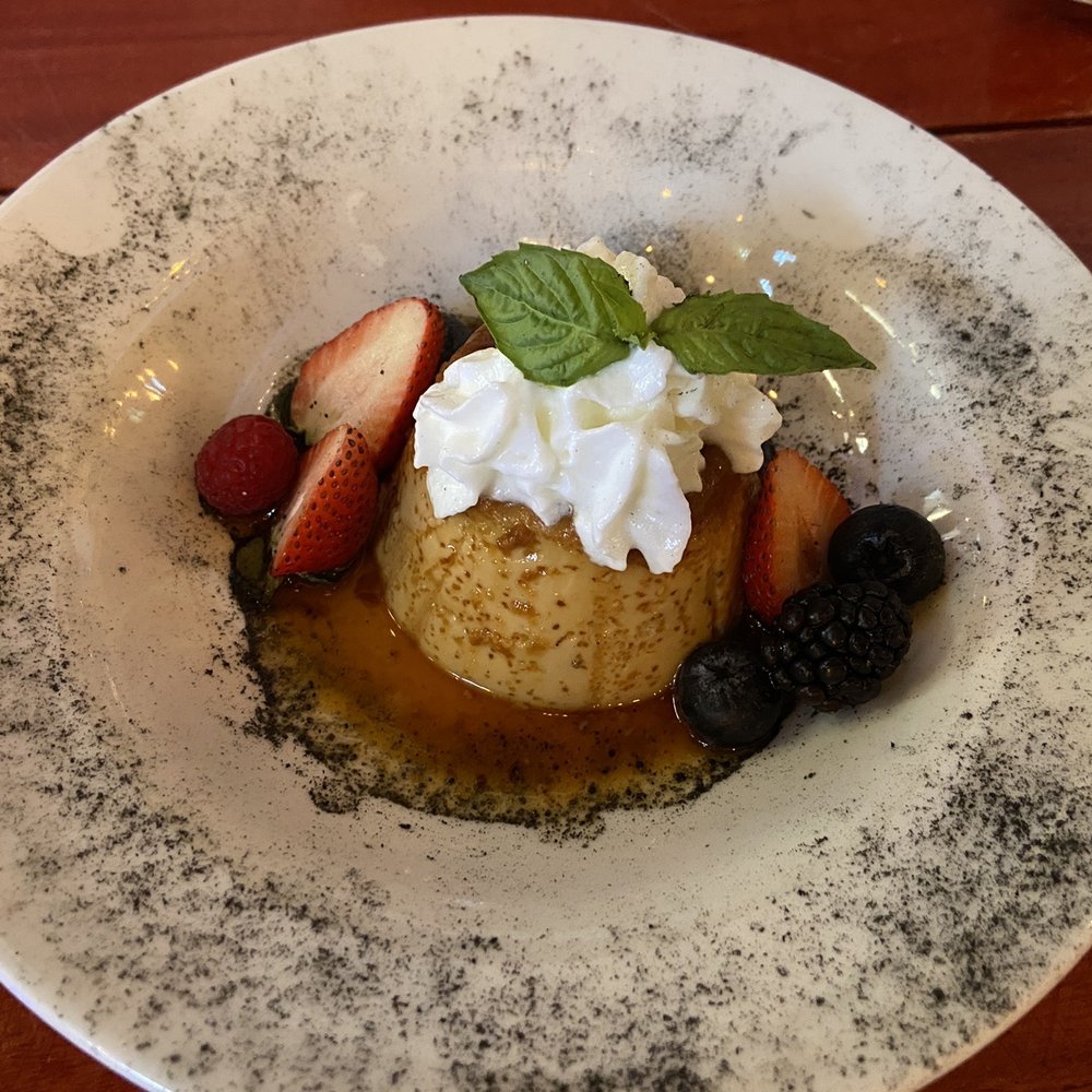 Merida Grill - Flan Dessert with fresh berries. - Mexican Near Me - Puerto Vallarta, JAL Merida Grill - Flan Dessert with fresh berries. - Mexican Near Me - Puerto Vallarta, JAL