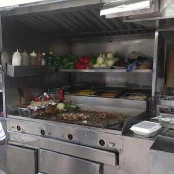 Halal Cart - a man and a woman preparing food - Street Vendors Near Me - New York, New York Halal Cart - a man and a woman preparing food - Street Vendors Near Me - New York, New York