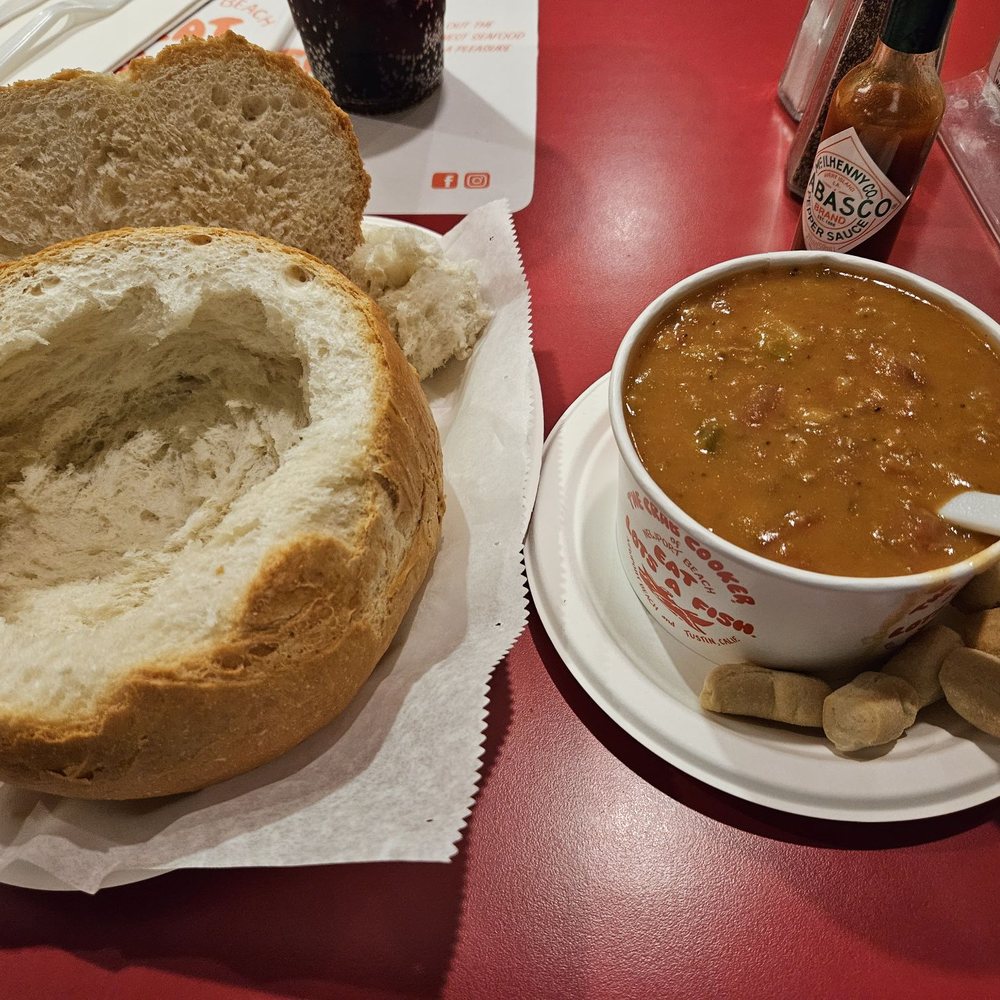 The Crab Cooker - Sour dough bread loaf hollowed out to use as a bread bowl for the clam chowder next to it. - Seafood Near Me - Tustin, California The Crab Cooker - Sour dough bread loaf hollowed out to use as a bread bowl for the clam chowder next to it. - Seafood Near Me - Tustin, California