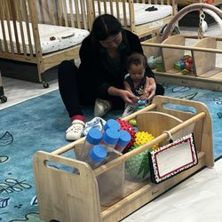 Children's Learning Adventure - Ms Nikko teaching my son how to push down on a toy. So gently and caring