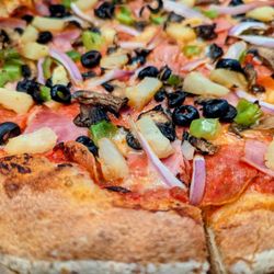 Suds Monkey Kitchen & Brewery Dripping Springs - Close up of the G.O.A.T. Pizza with No Sausage and added Pineapple