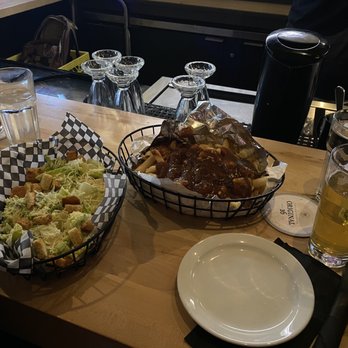 Eddie Burger + Bar - Left: Caesar salad ($13), Right: Poutine ($12) - Burgers Near Me - Banff, Alberta Eddie Burger + Bar - Left: Caesar salad ($13), Right: Poutine ($12) - Burgers Near Me - Banff, Alberta