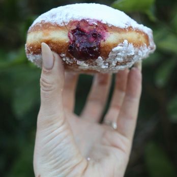 Cal’s Bakeshop - a hand holding a doughnut - Bakeries Near Me - Tucson, Arizona Cal’s Bakeshop - a hand holding a doughnut - Bakeries Near Me - Tucson, Arizona