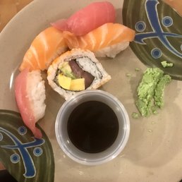 Ahi tuna and Salmon Sashimi and a sushi roll of some sort Ahi tuna and Salmon Sashimi and a sushi roll of some sort