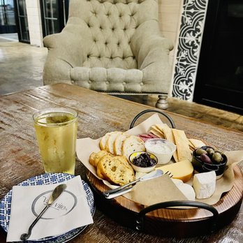 Vita Vite Midtown - a plate of cheese, crackers, olives, and a glass of wine - Wine Bars Near Me - Raleigh, North Carolina
