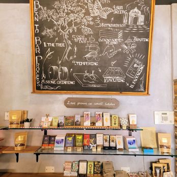 Chokolà - a chalkboard and shelves of books - Chocolatiers & Shops Near Me - Taos, New Mexico