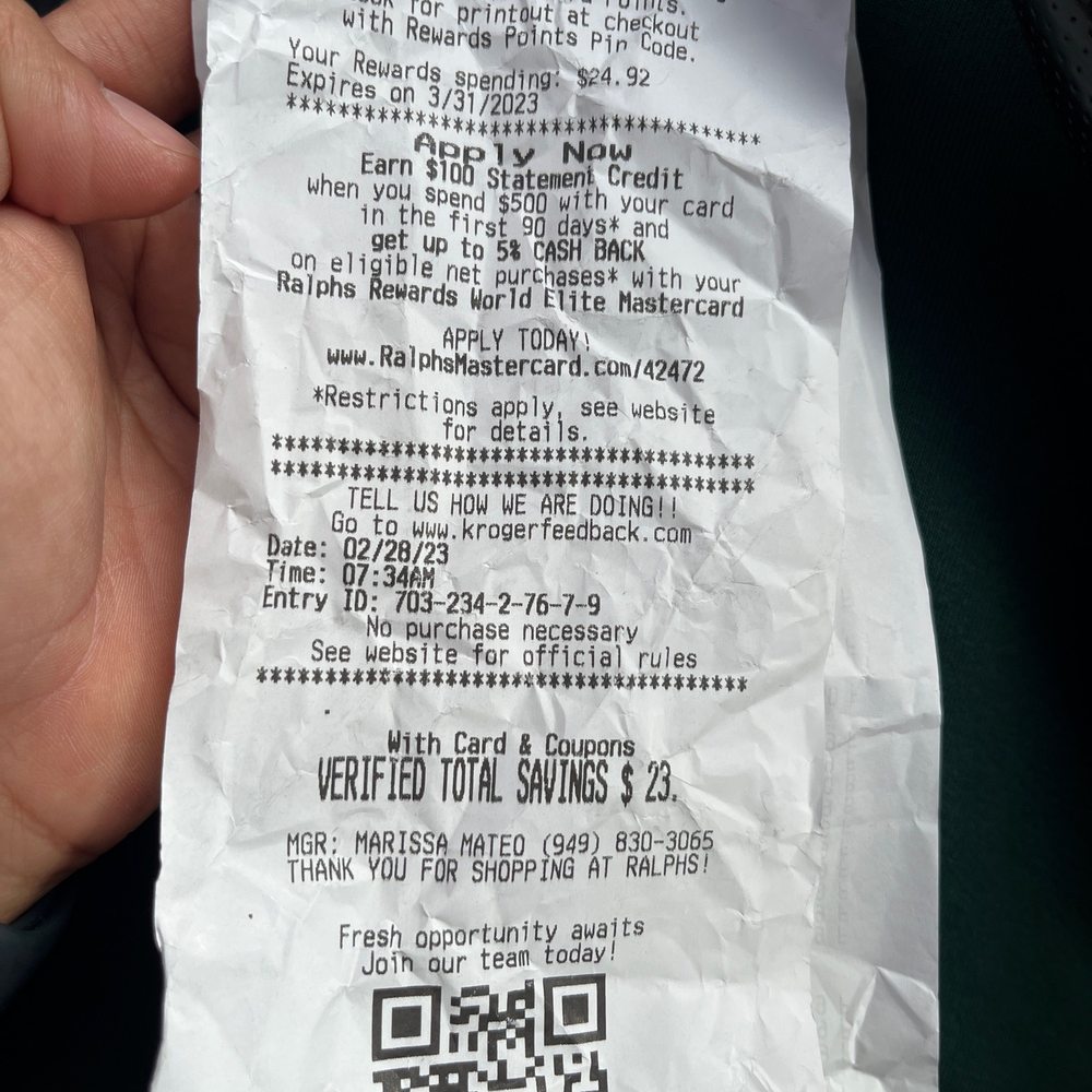 a person holding a piece of paper with a qr code on it