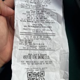 a person holding a piece of paper with a qr code on it a person holding a piece of paper with a qr code on it