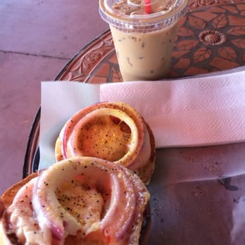 City Bagel - Garlic bagel with Swiss cheese tomatoe and onion Melt with an iced latte to wash it down - Bagels Near Me - Placentia, California